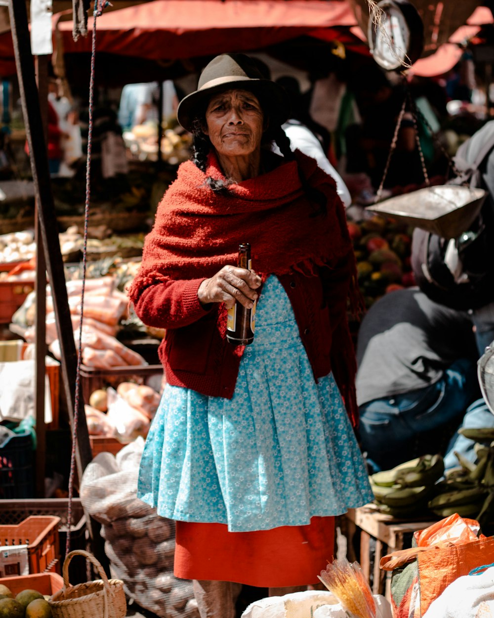 woman holding amber glass bottle