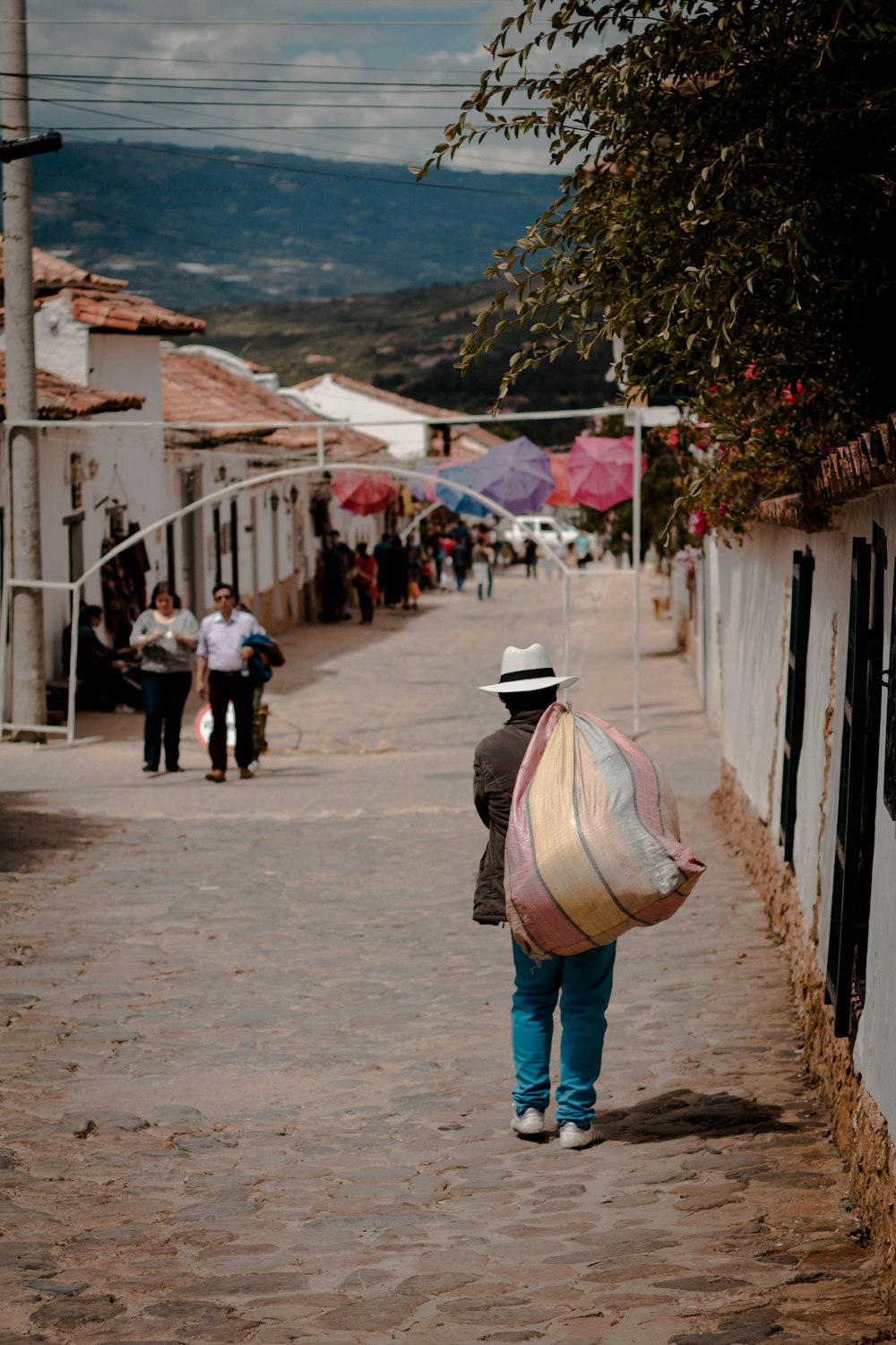 man carrying sack on road