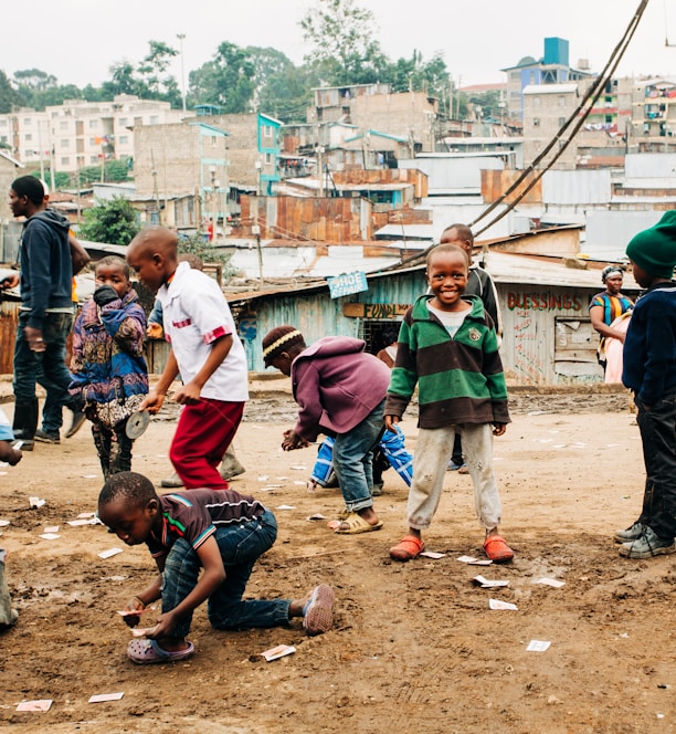 children playing on brown sand at daytime