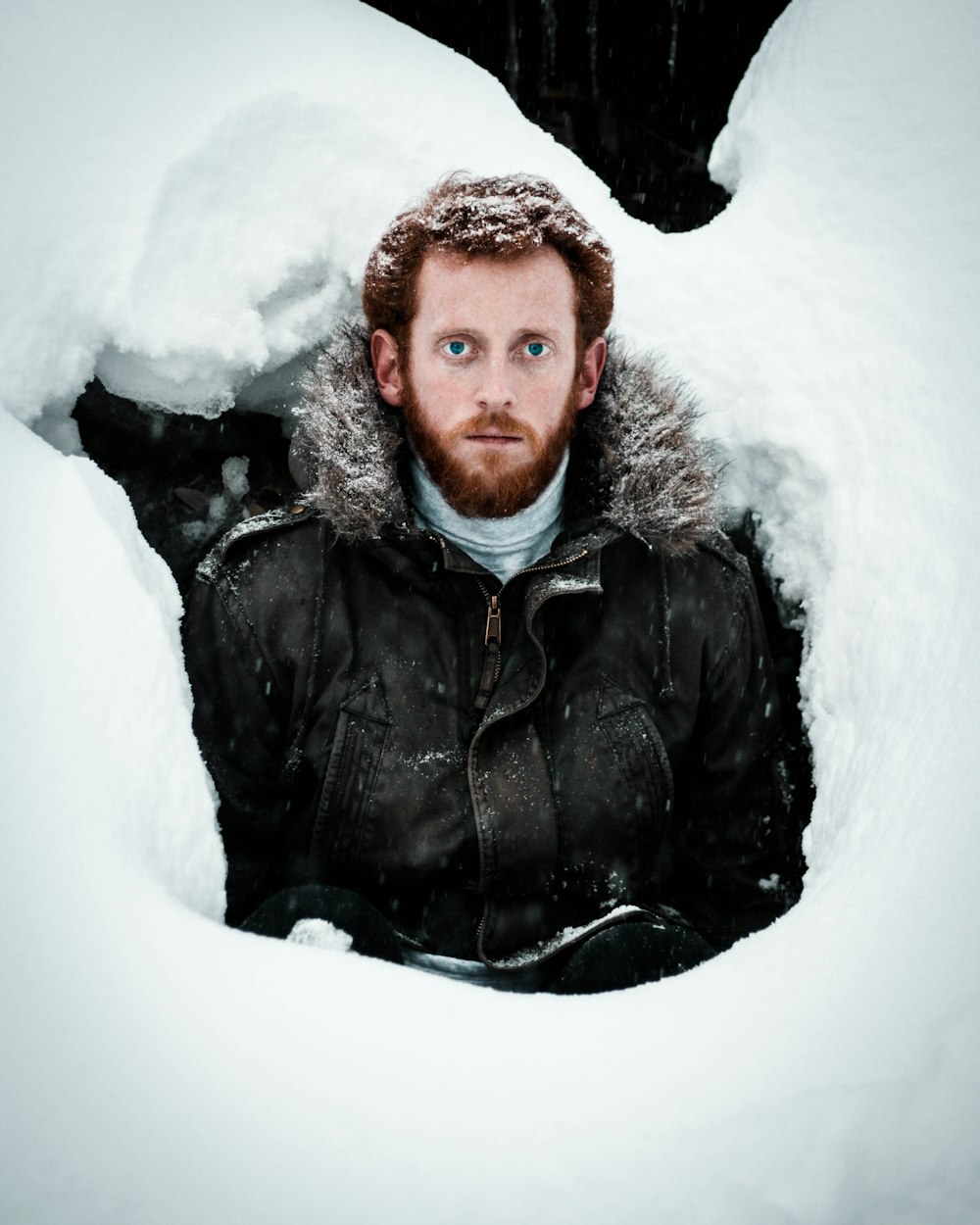 man in black leather jacket on snow