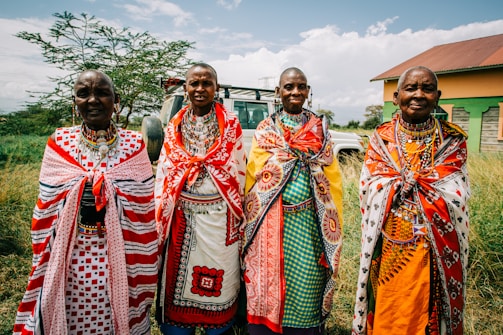 four people wearing traditional dresses