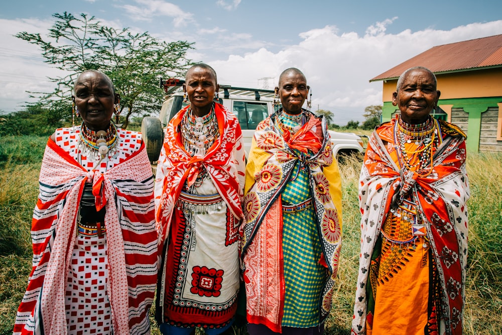 four people wearing traditional dresses