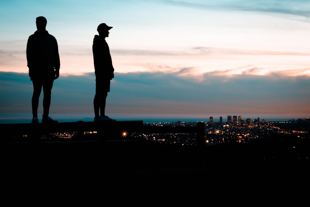 silhouette of two men standing