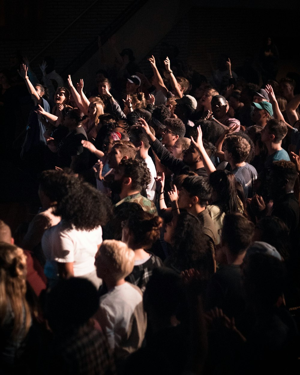 group of people putting hands up