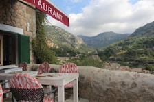 A scenic view of a traditional restaurant with outdoor seating and local cuisine.