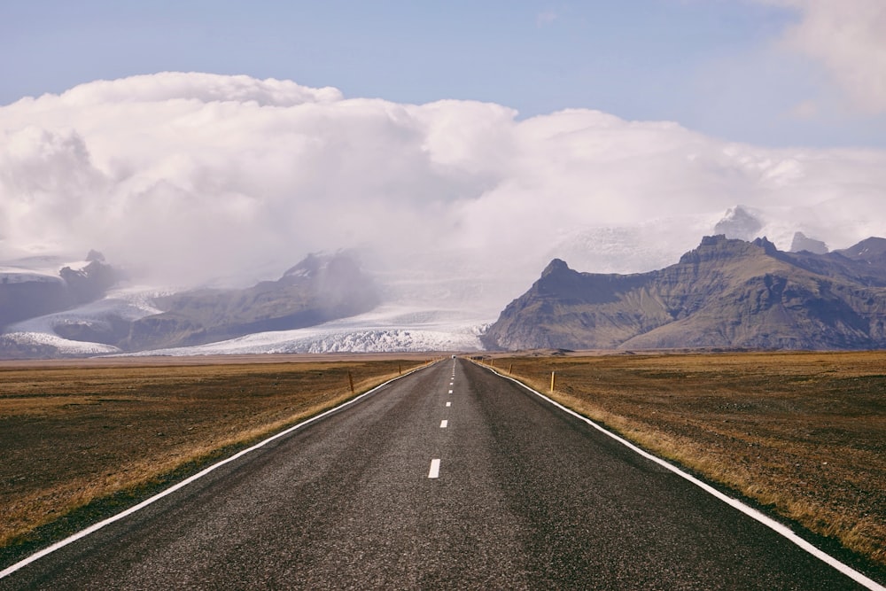 asphalt road between mountain range during daytime