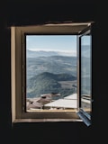 brown and white huts and sheds outdoor view from opened glass window
