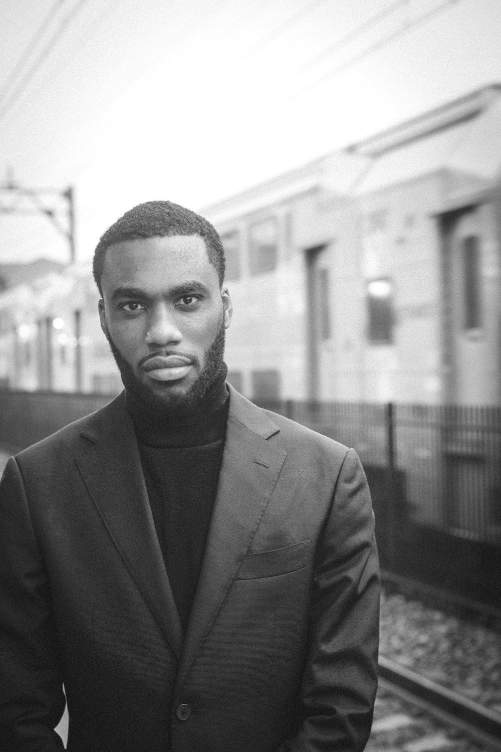 grayscale photo of man in suit