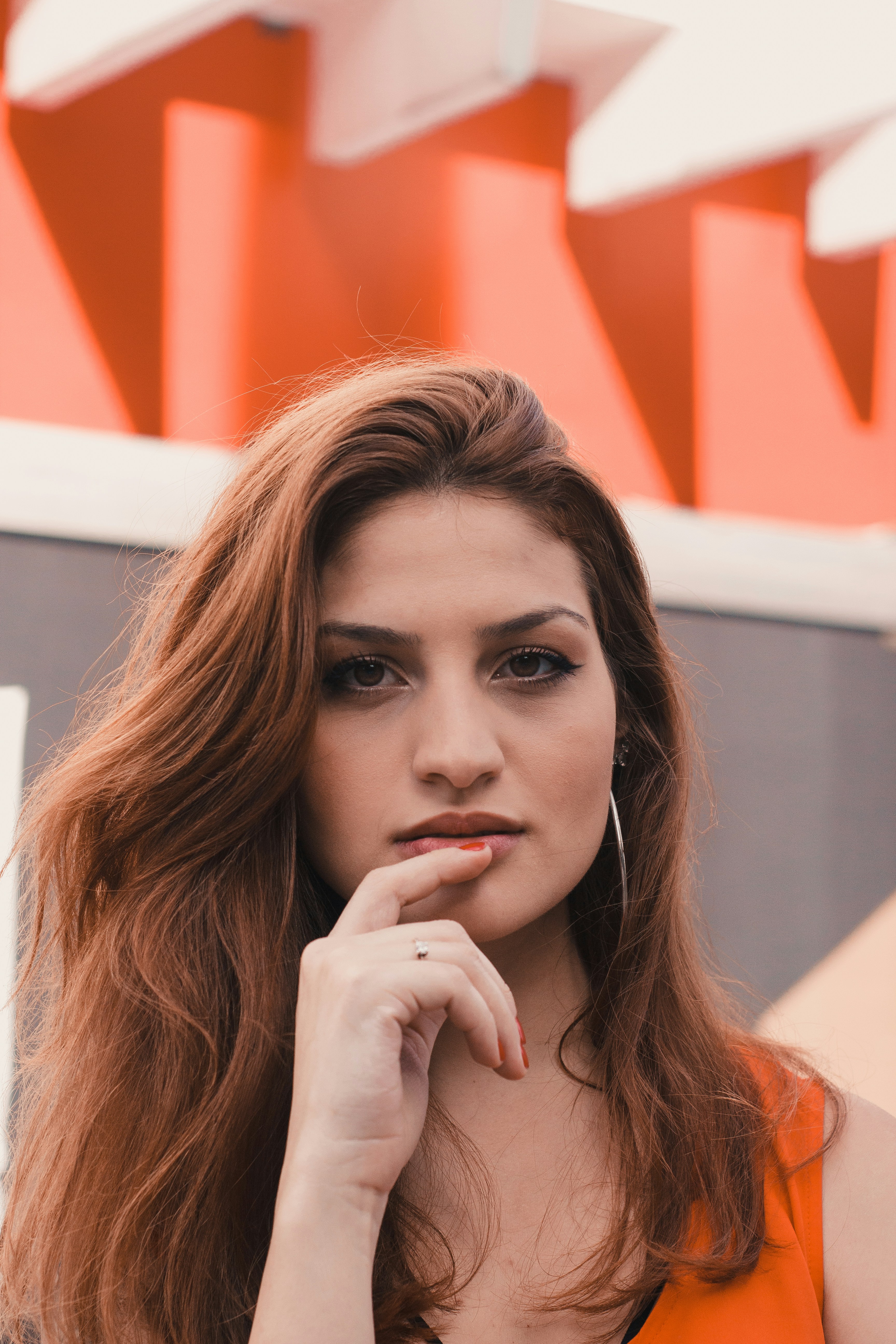 woman in orange sleeveless top