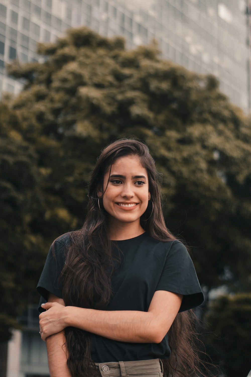 smiling woman standing near building