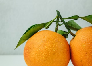two orange fruits on table