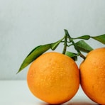 two orange fruits on table