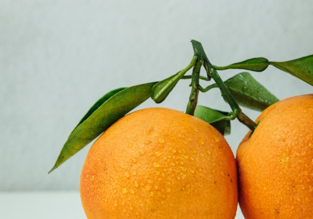 two orange fruits on table