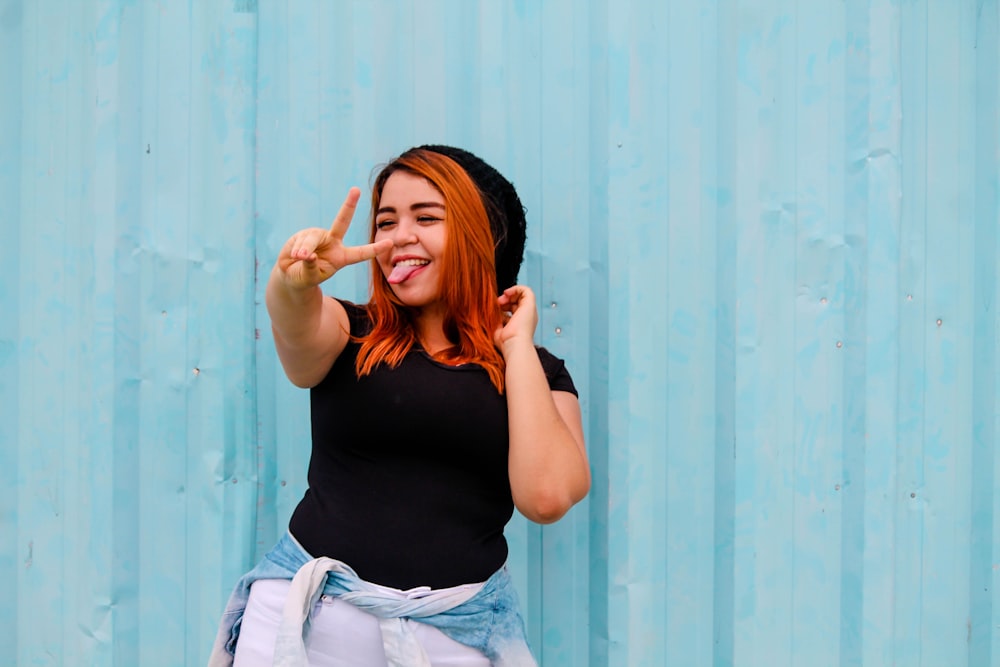 woman showing peace hand sign