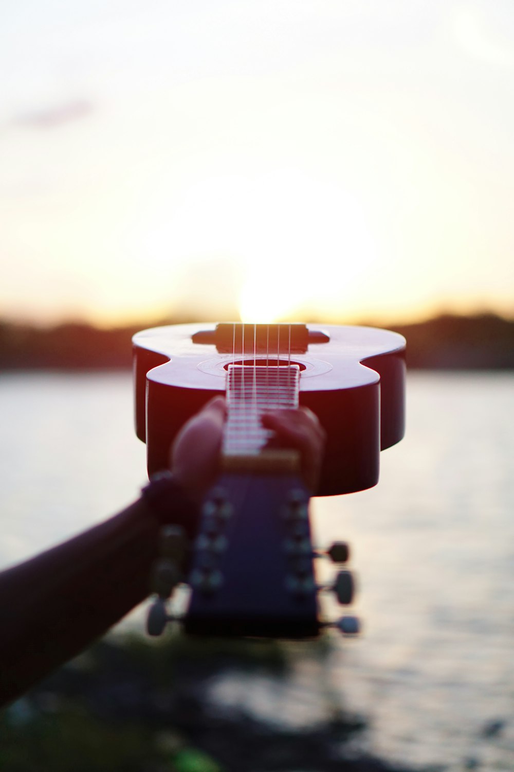 selective focus photography of acoustic guitar