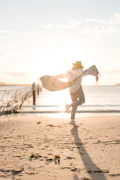 person in white sport shirt on shore during golden hour