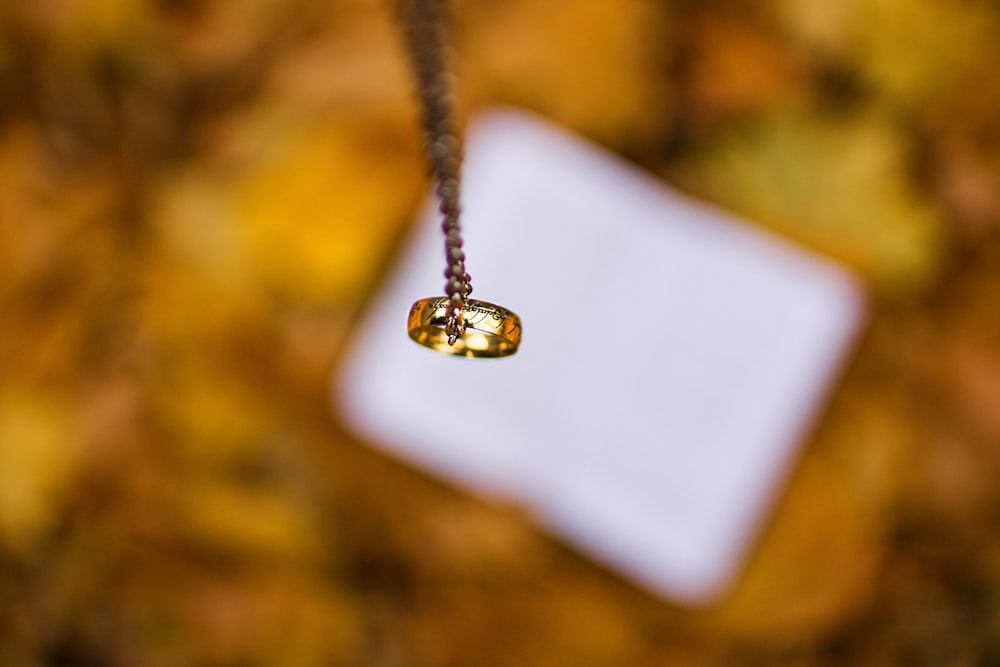 gold-colored ring pendant