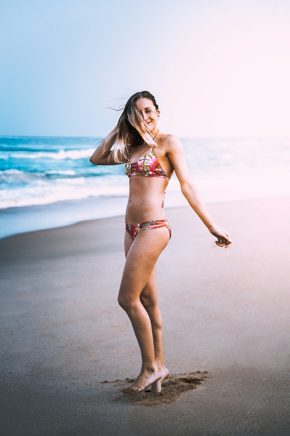 woman wearing bikini standing on shore