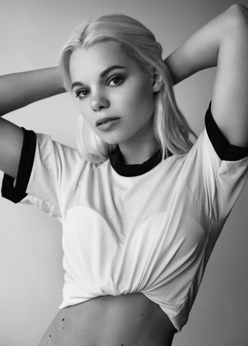 grayscale photo of woman in white crop top