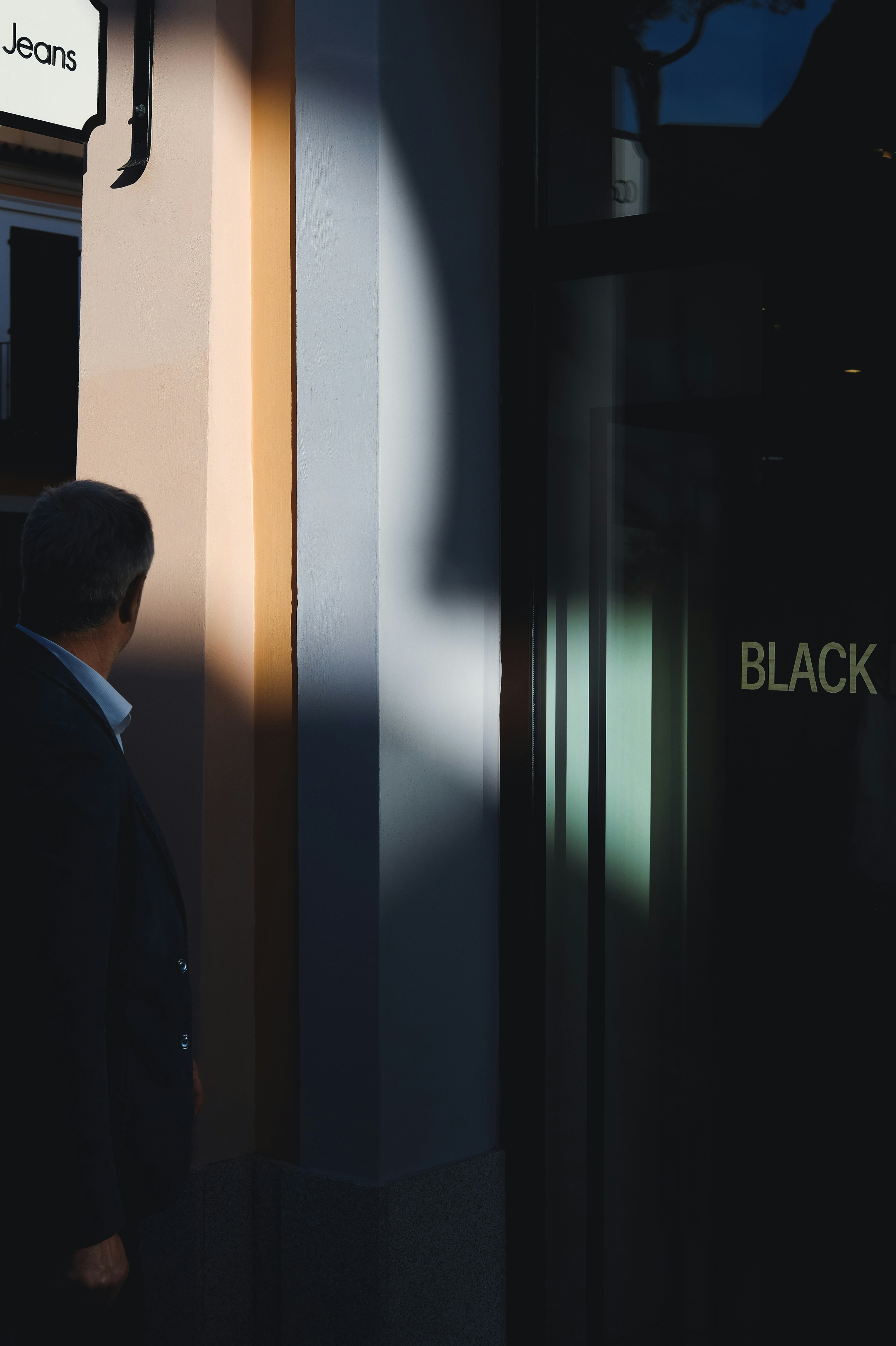 Person Standing Near Black Printed Door Photo Free Human Image