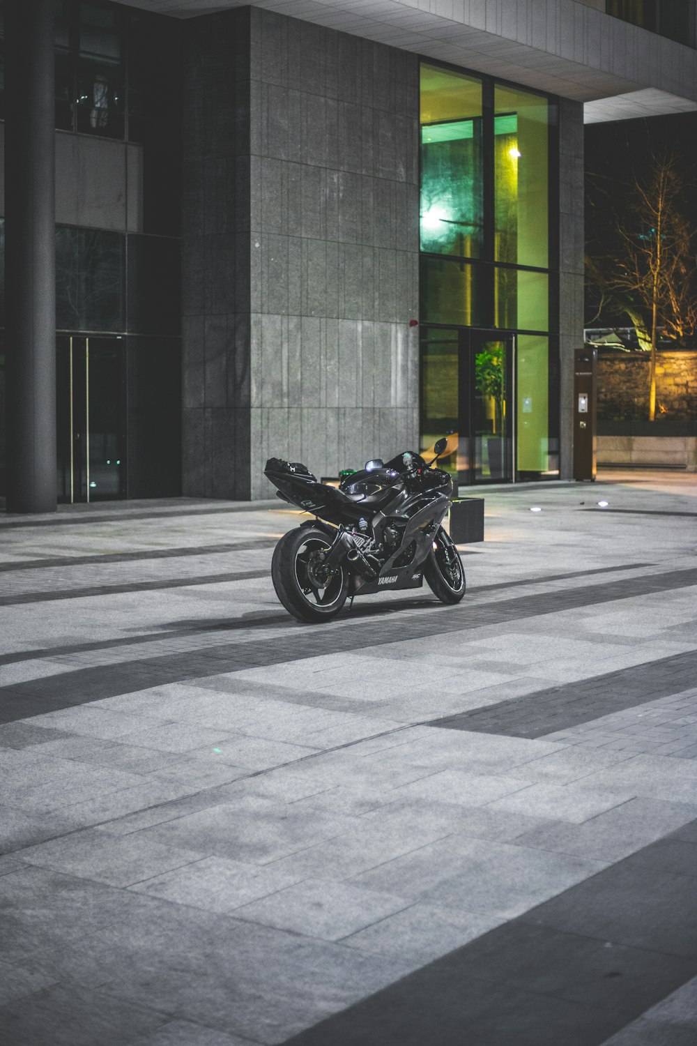 black sport bike beside building