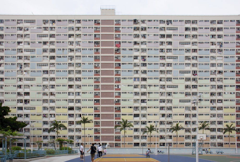 group of people walking near concrete building