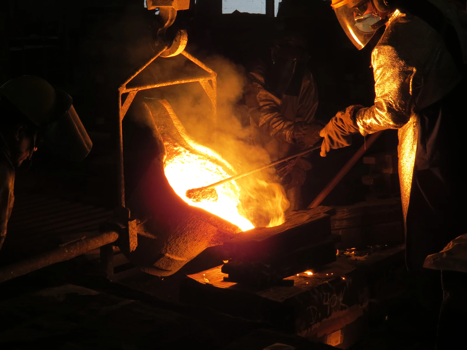 Hands forming a brass whistle on the factory floor