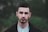 man in black coat in selective focus photo