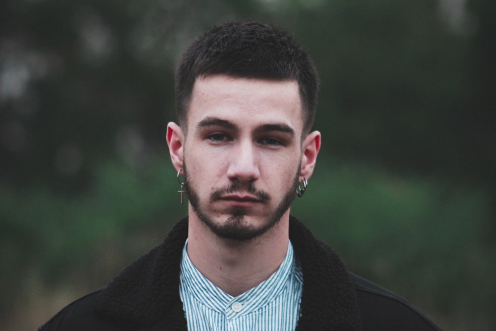 man in black coat in selective focus photo