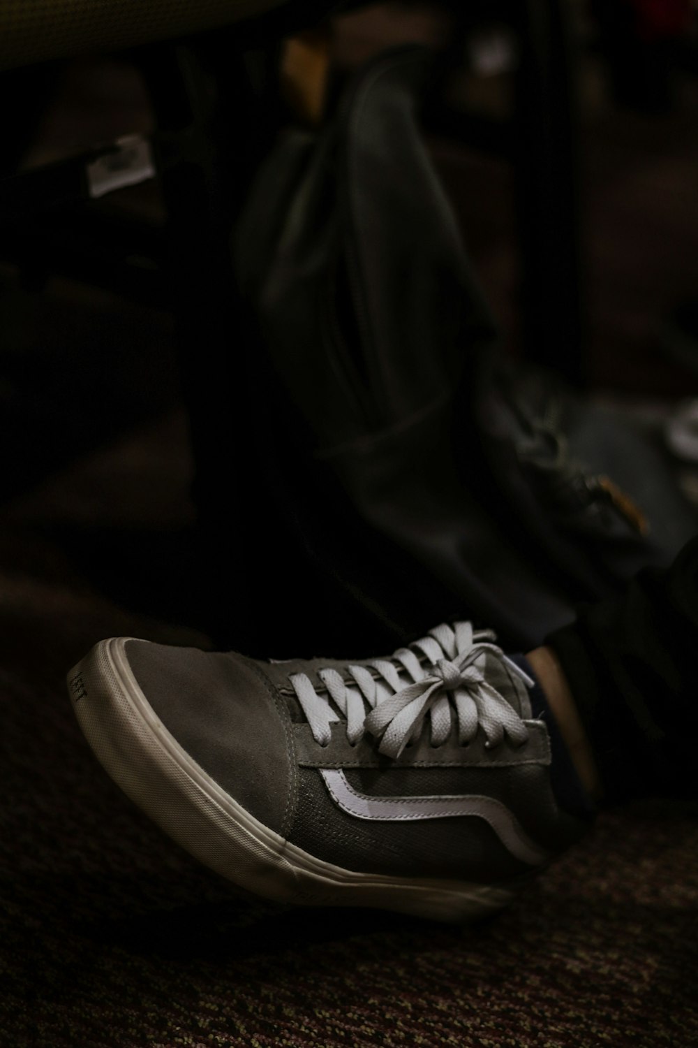 person wearing gray Puma sneaker