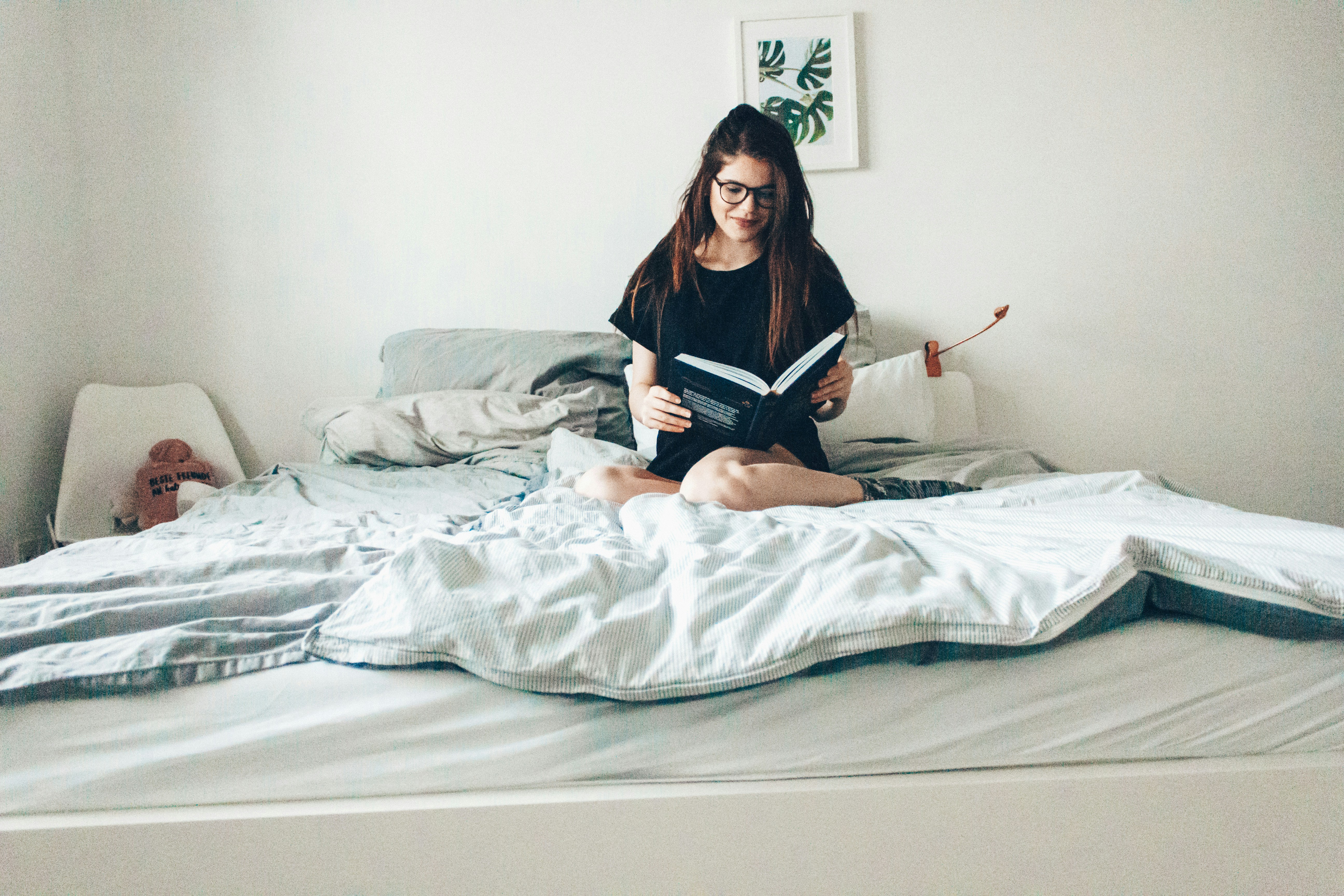 girl reading in bed