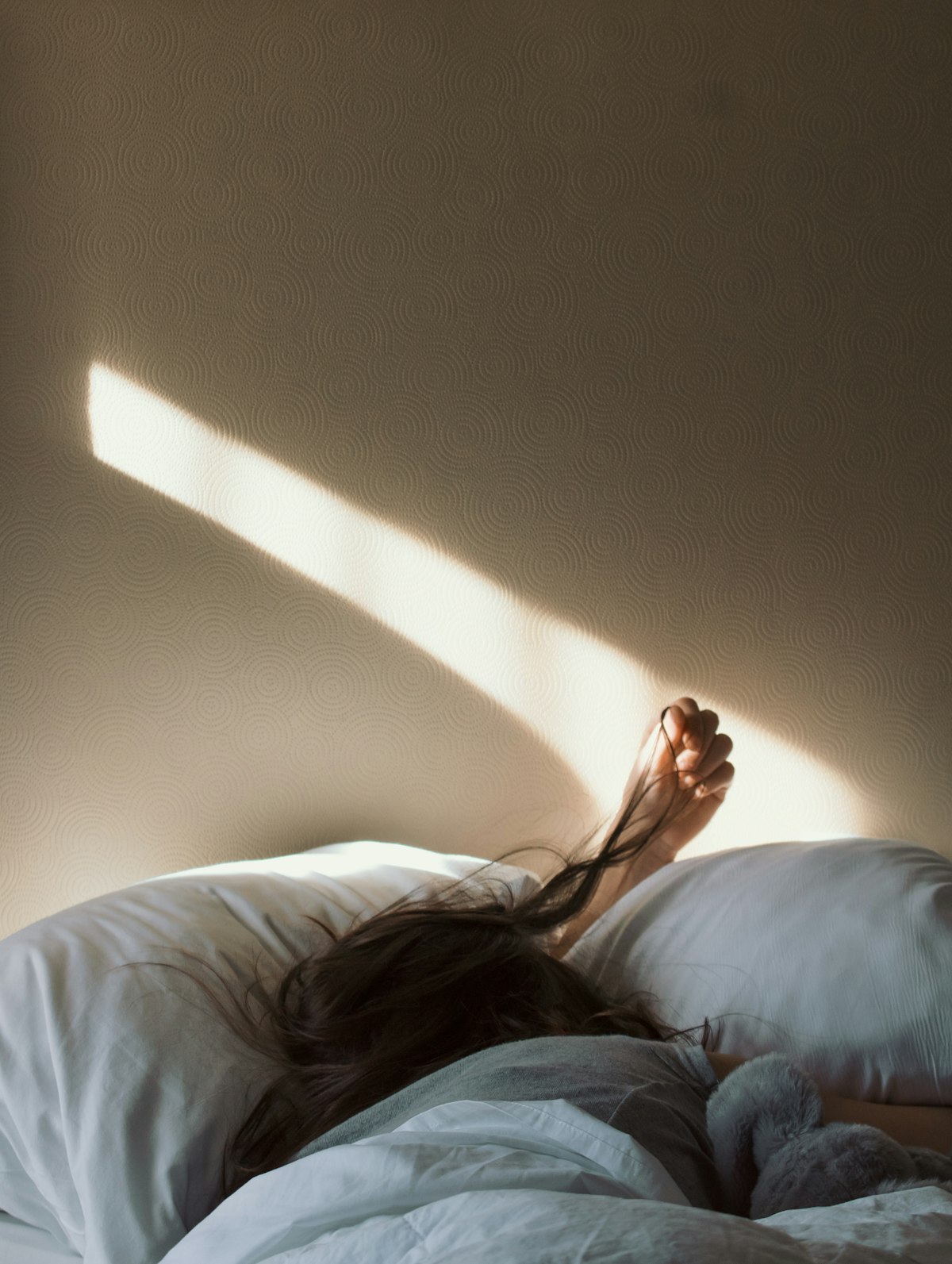 Woman lying on a bed, quiet restful sleep register