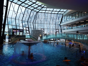 Interior view of a covered swimming pool with solar-powered heating system visible.