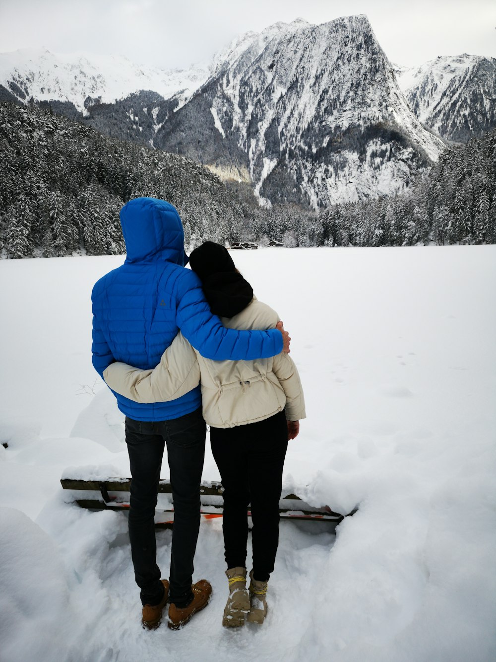 man and woman surrounded by snow