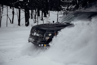 A rugged truck driving through snowy terrain delivering supplies.