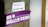A concrete pillar features two signs taped to it. The top sign is white with the words 'WiFi Password: WE WANT MORE' printed in purple. Below it, a larger purple banner displays Korean text in white, translated as 'Welcome to Feminist Utopia.'