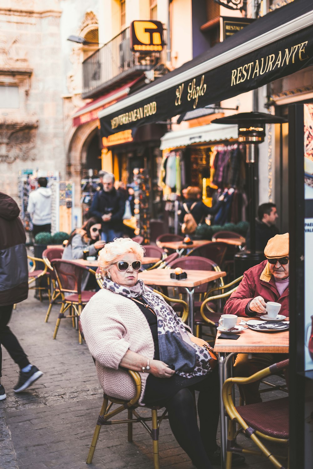 woman sitting on chair outside the restaurant