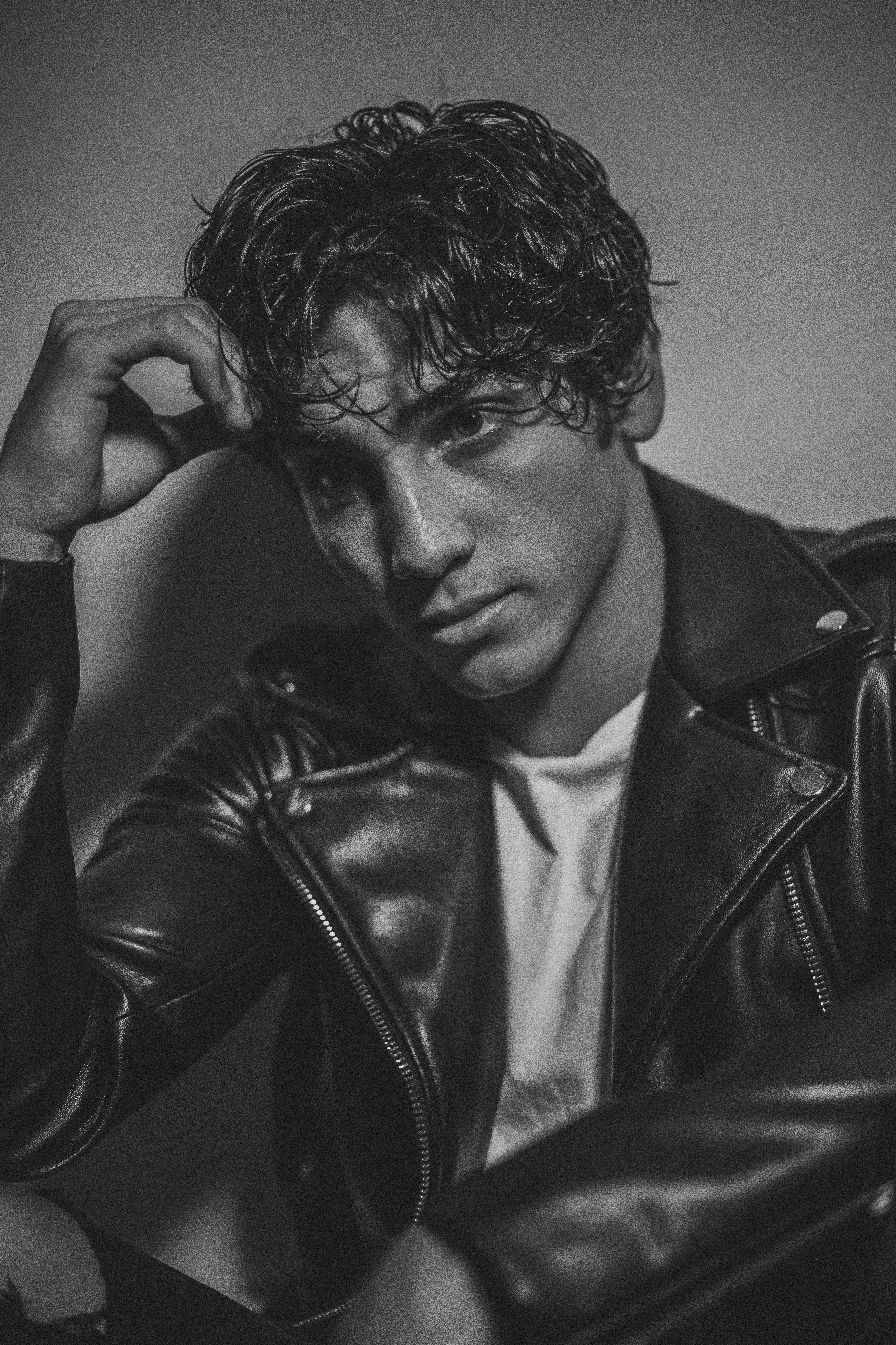 Man Wearing Leather Jacket Resting Head On Hand Photo Free Apparel Image On Unsplash