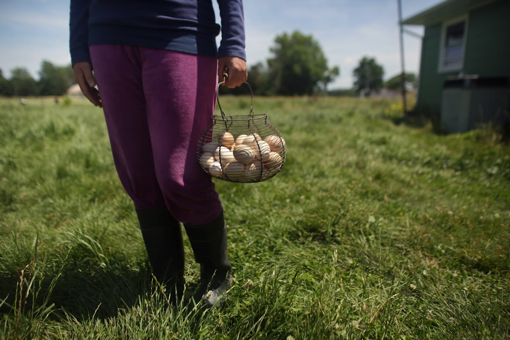 woman holding basket of egg