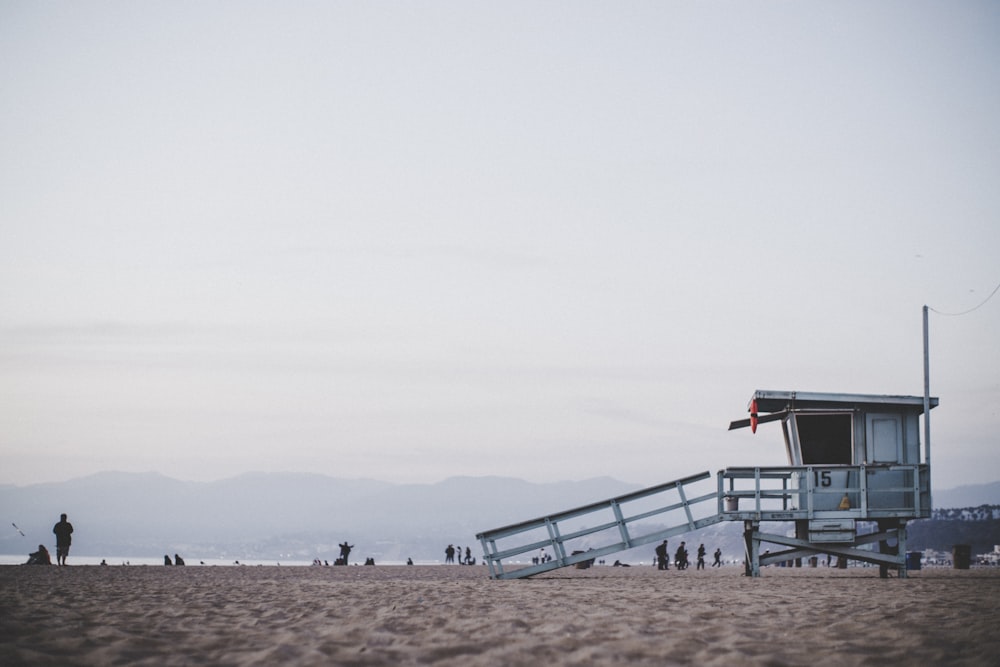 white guard post in the beach during daytime