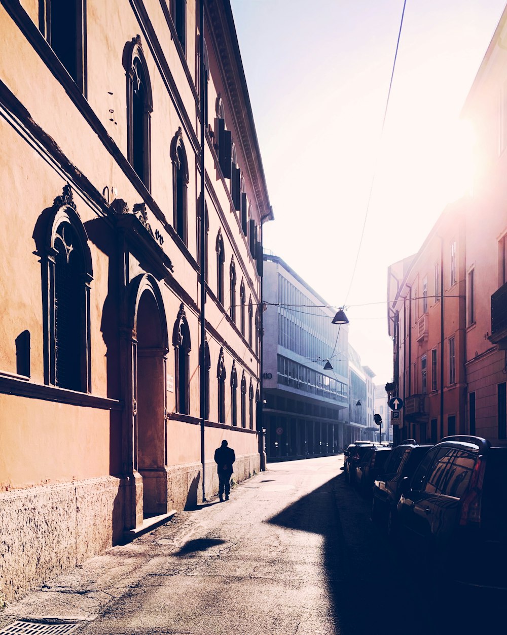 man standing beside building