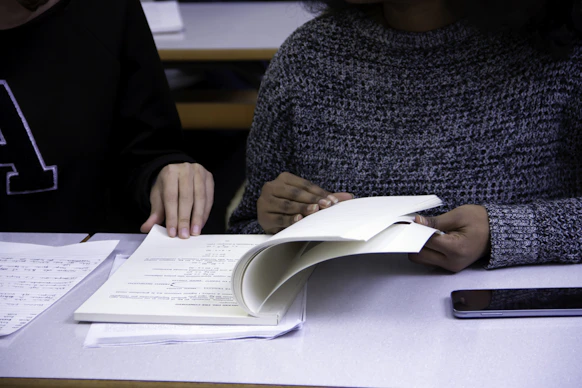 black woman flipping book page with man
