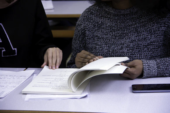 black woman flipping book page with man