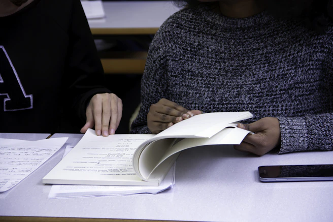 black woman flipping book page with man