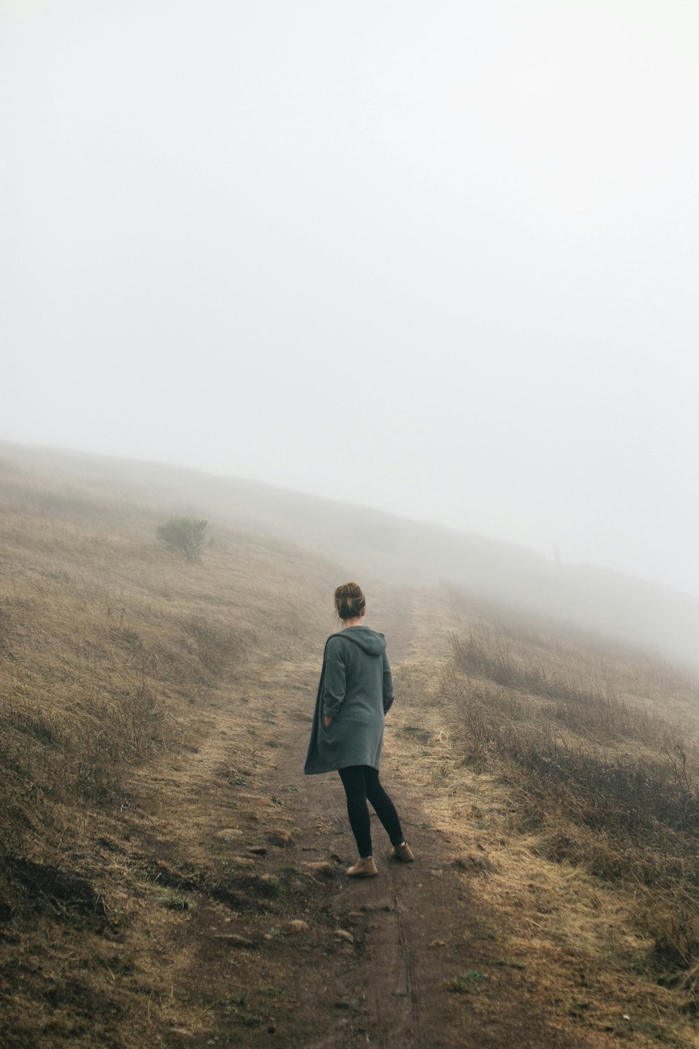 woman standing in the middle of road