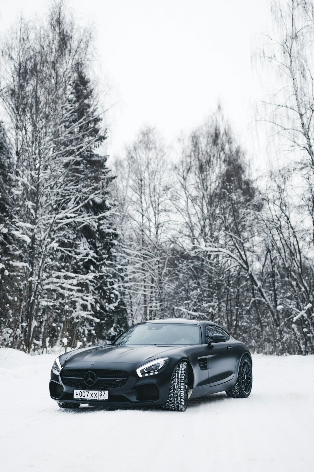 black BMW coupe across trees