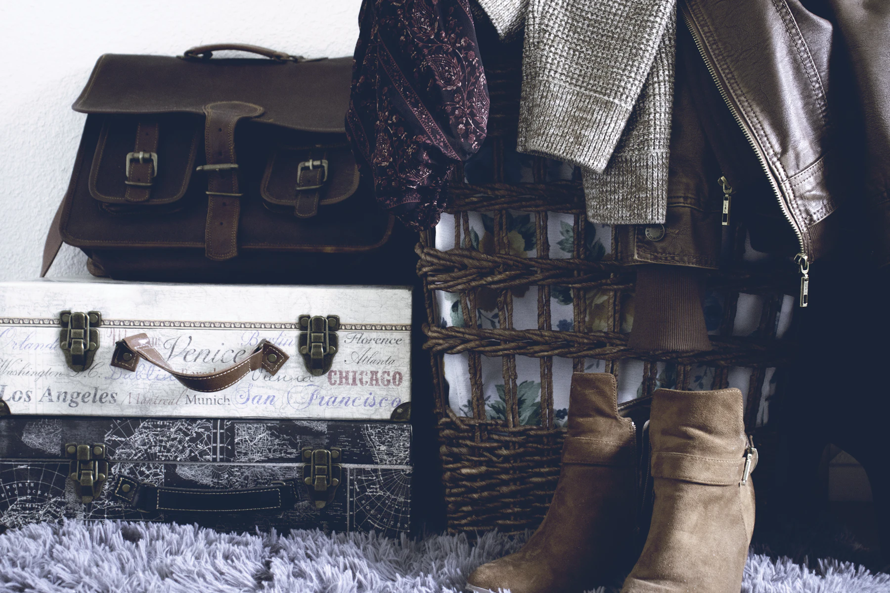 Boots and travel luggage packed for an autumn trip