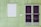 The image depicts a green exterior wall of a building with vertical panel siding. There is a white roll-down shutter covering the window on the left, and a double door with dark, almost opaque, glass panels on the right. There is also a small white mailbox or nameplate mounted on the wall between the window and the door.