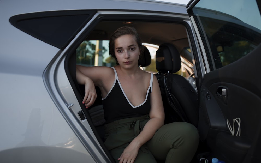 woman in black sleeveless top inside car