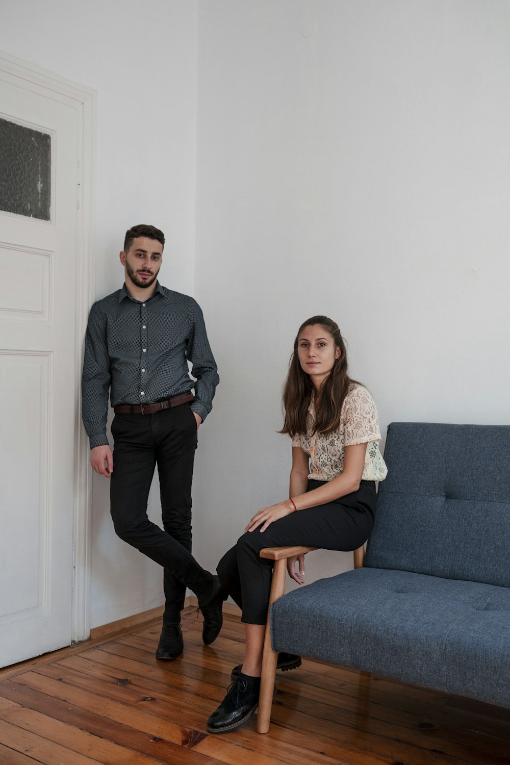 standing man beside sitting woman